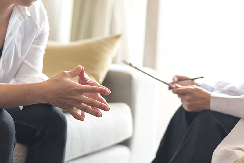 A person talks to a doctor about starting medication-assisted treatment in an outpatient rehab program.