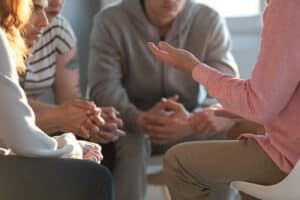 A professional interventionist talks to family members to help plan an intervention.