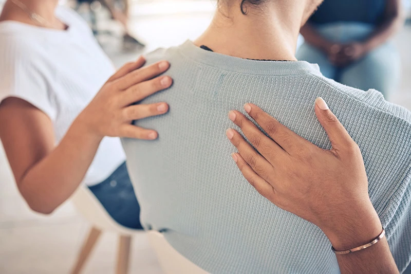 People support each other in a recovery group.